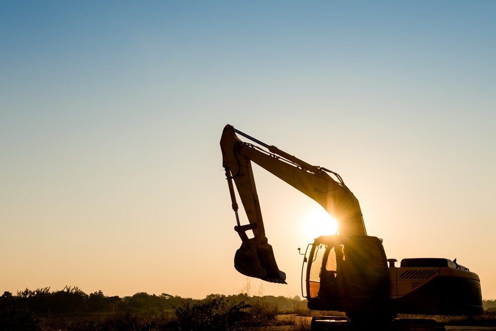 A Large Excavator is Silhouetted Against a Sunset Sky — Koumala Quarry In Nebo, QLD