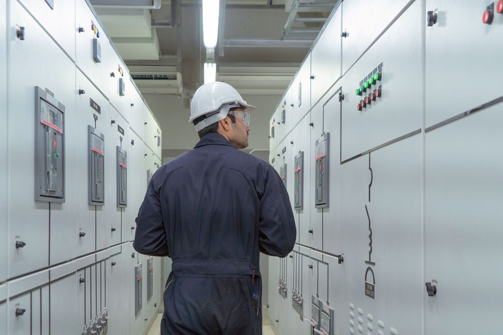 Electrician in a White Hard Hat and Jumpsuit — KAC Generation & Mechanical Pty Ltd In Bungalow, QLD