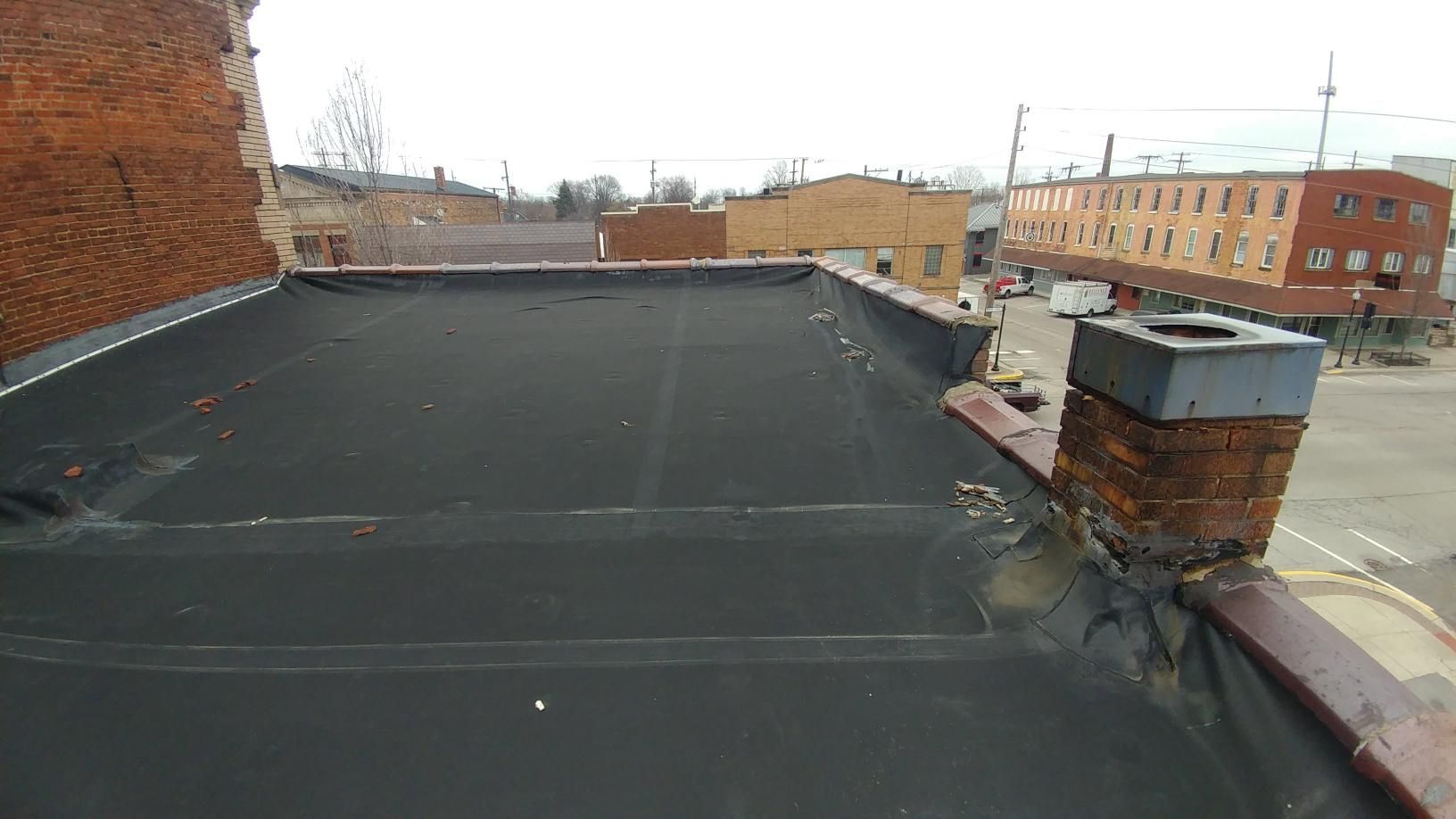 There is a chimney on the roof of a building.