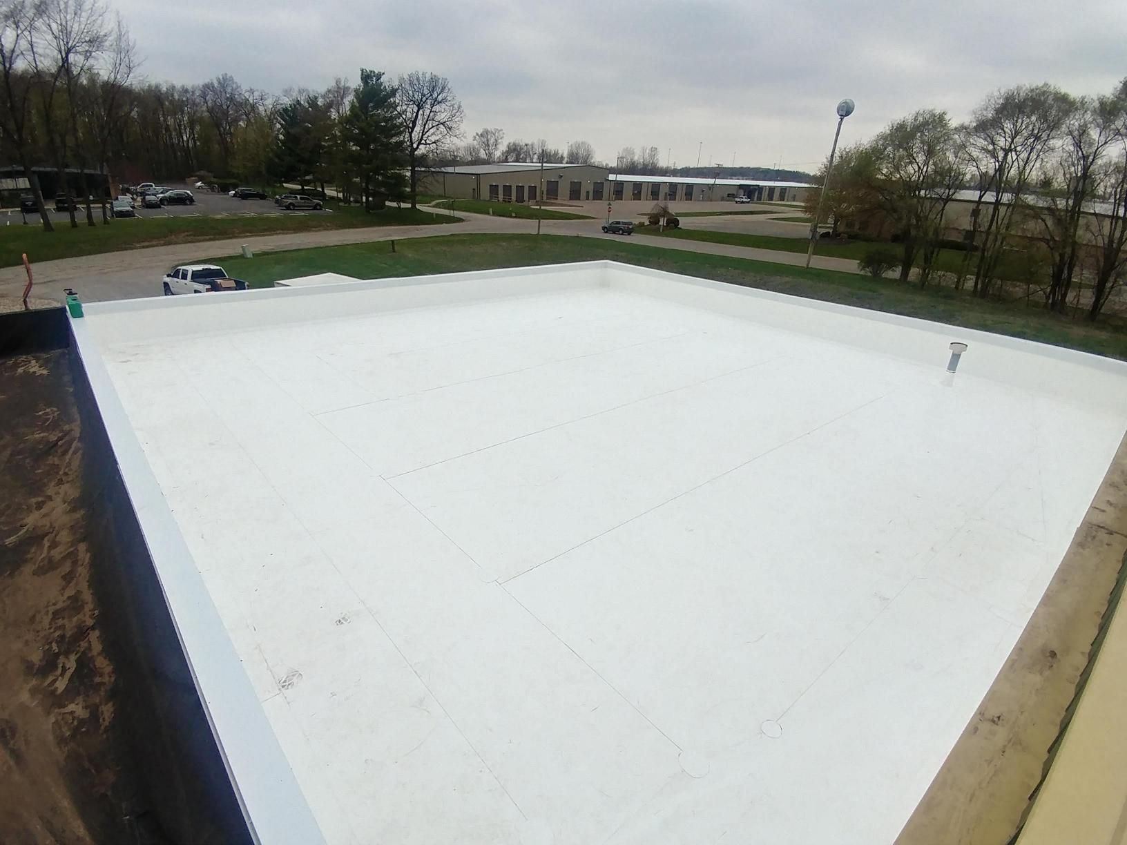 A white roof is being installed on top of a building.
