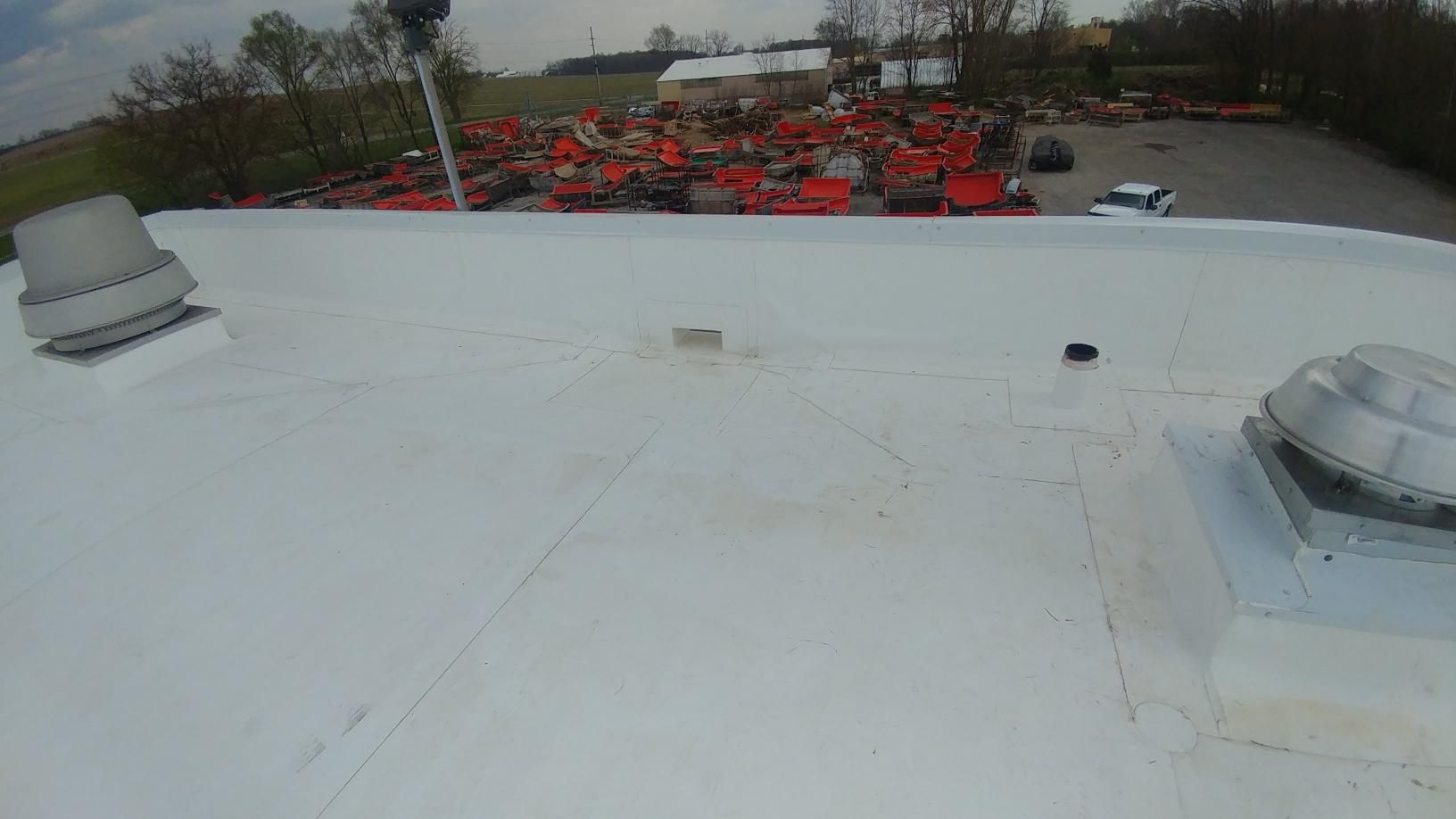 A white roof with a skylight on top of it.