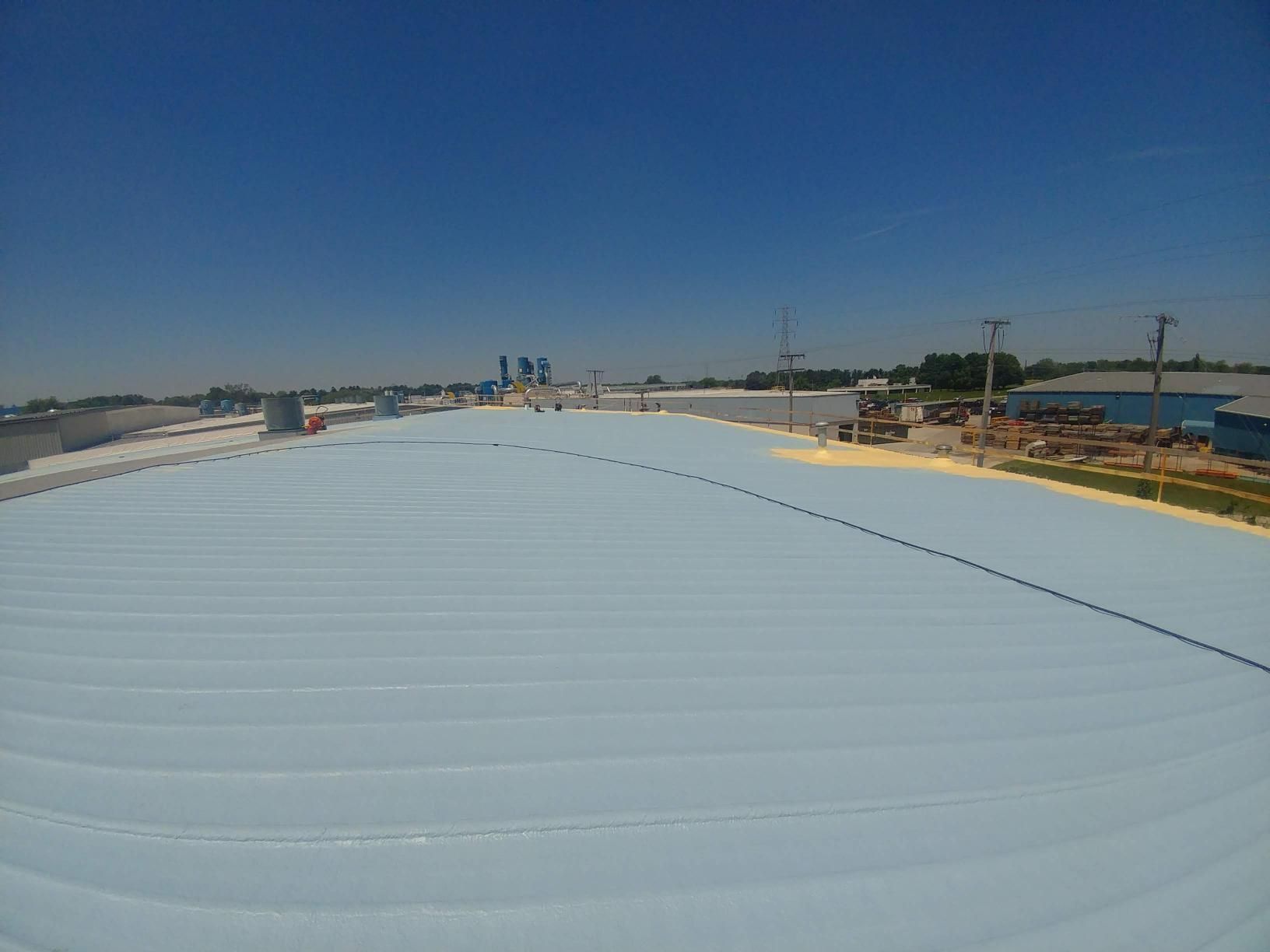 A large white roof with a blue sky in the background