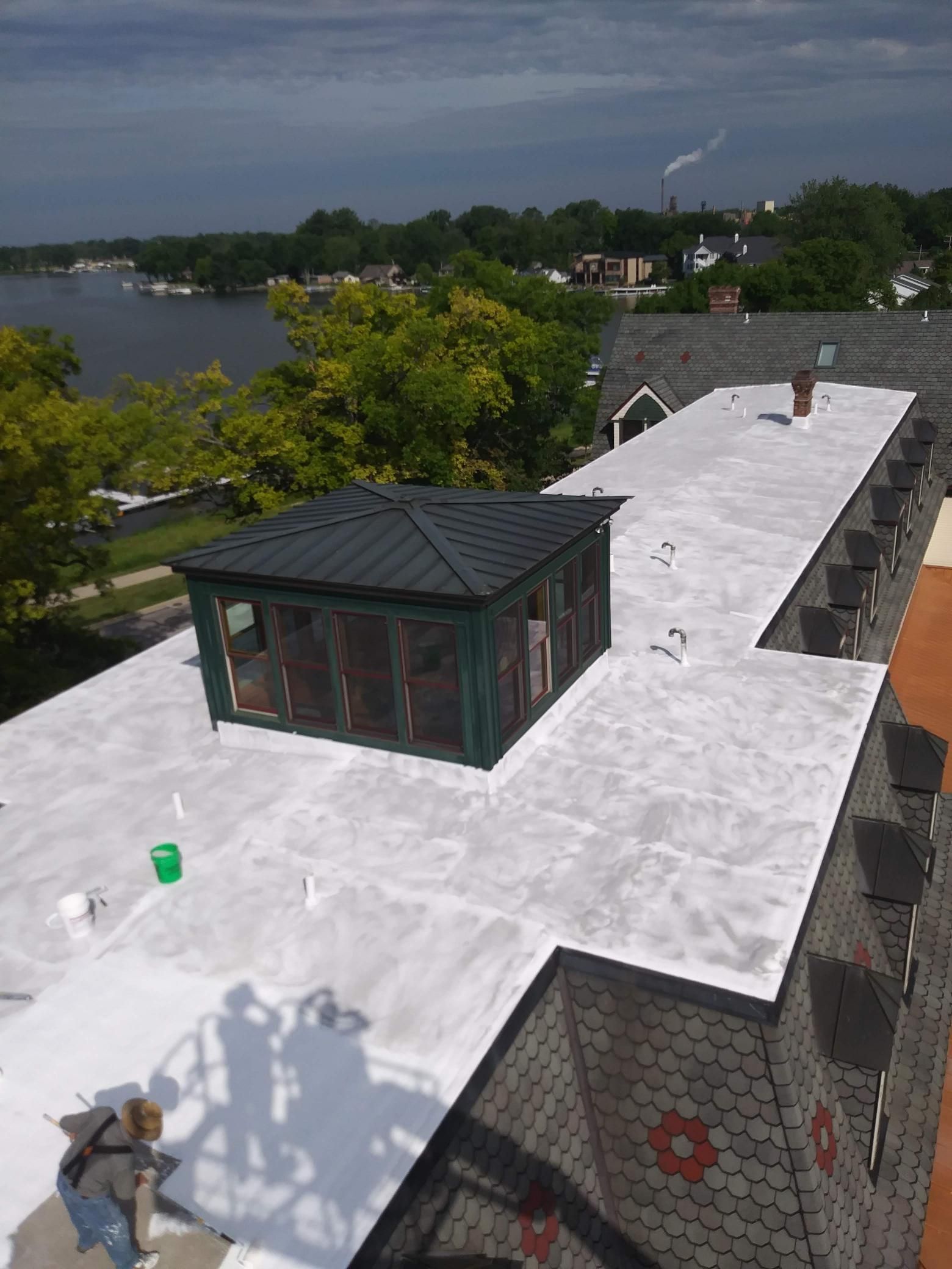 An aerial view of a building with a white roof.