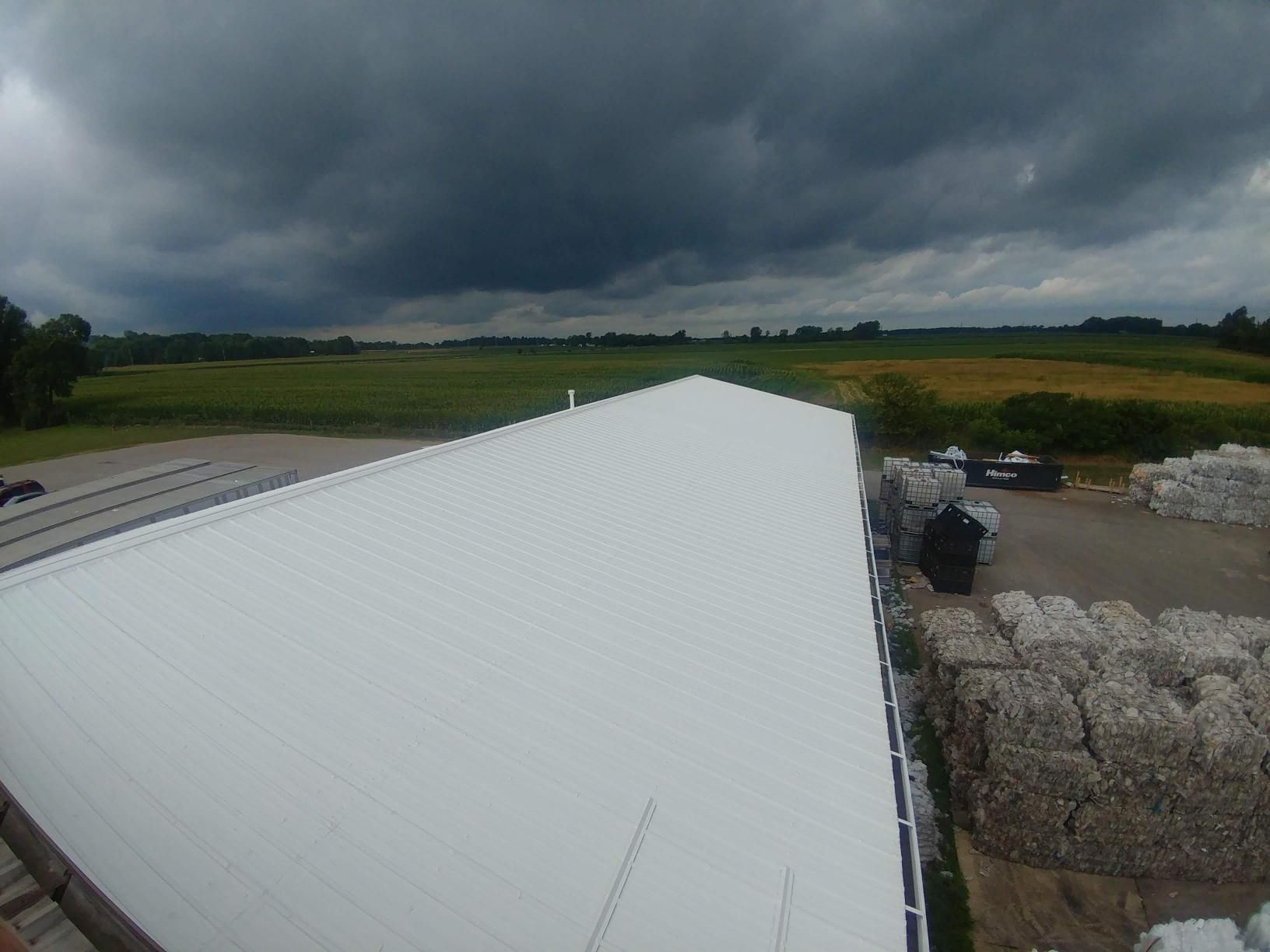 A large white building with a cloudy sky in the background.