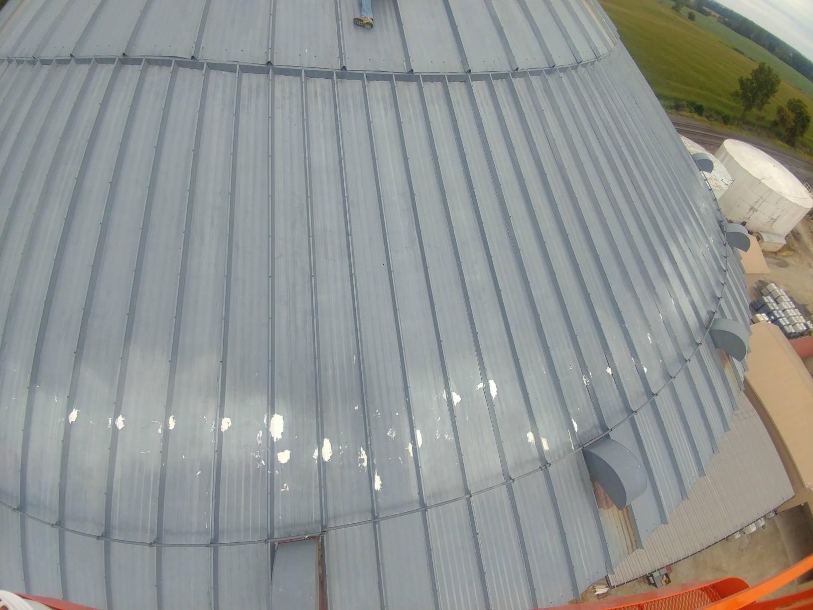 An aerial view of a large dome with a metal roof.