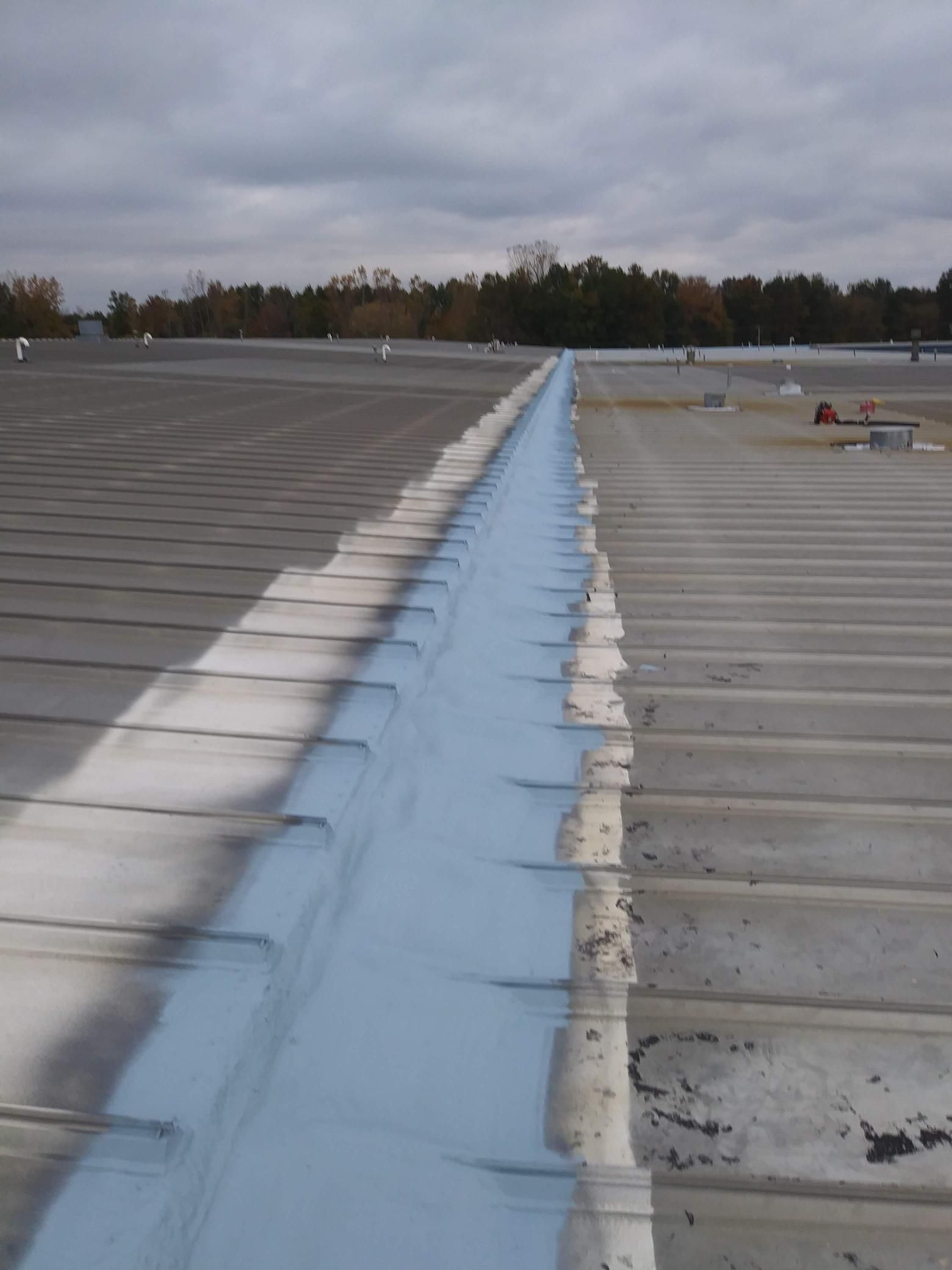 A roof with a blue gutter on it