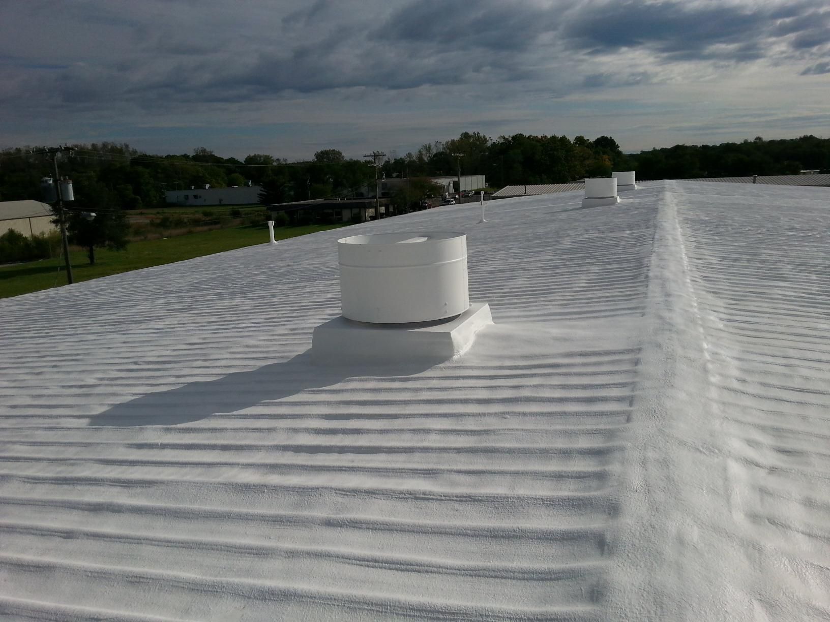 A white roof with a fan on top of it.