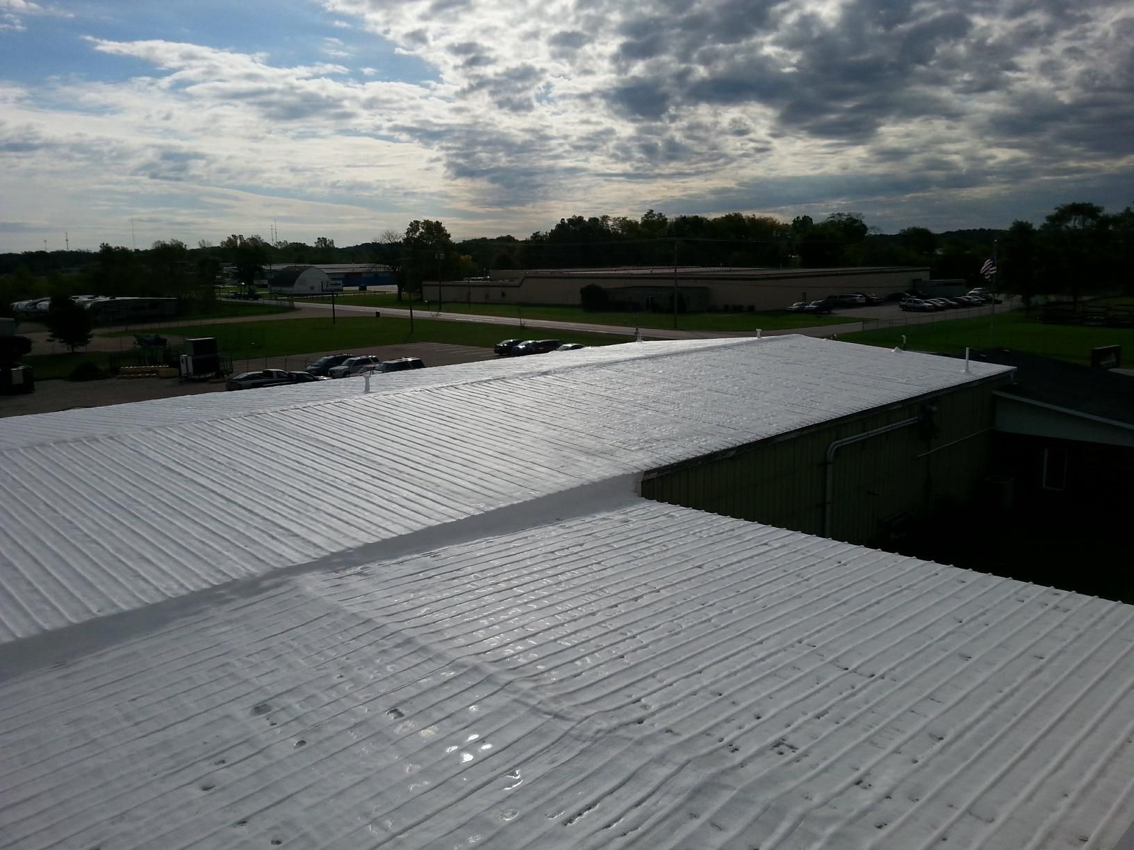 A white roof with a cloudy sky in the background