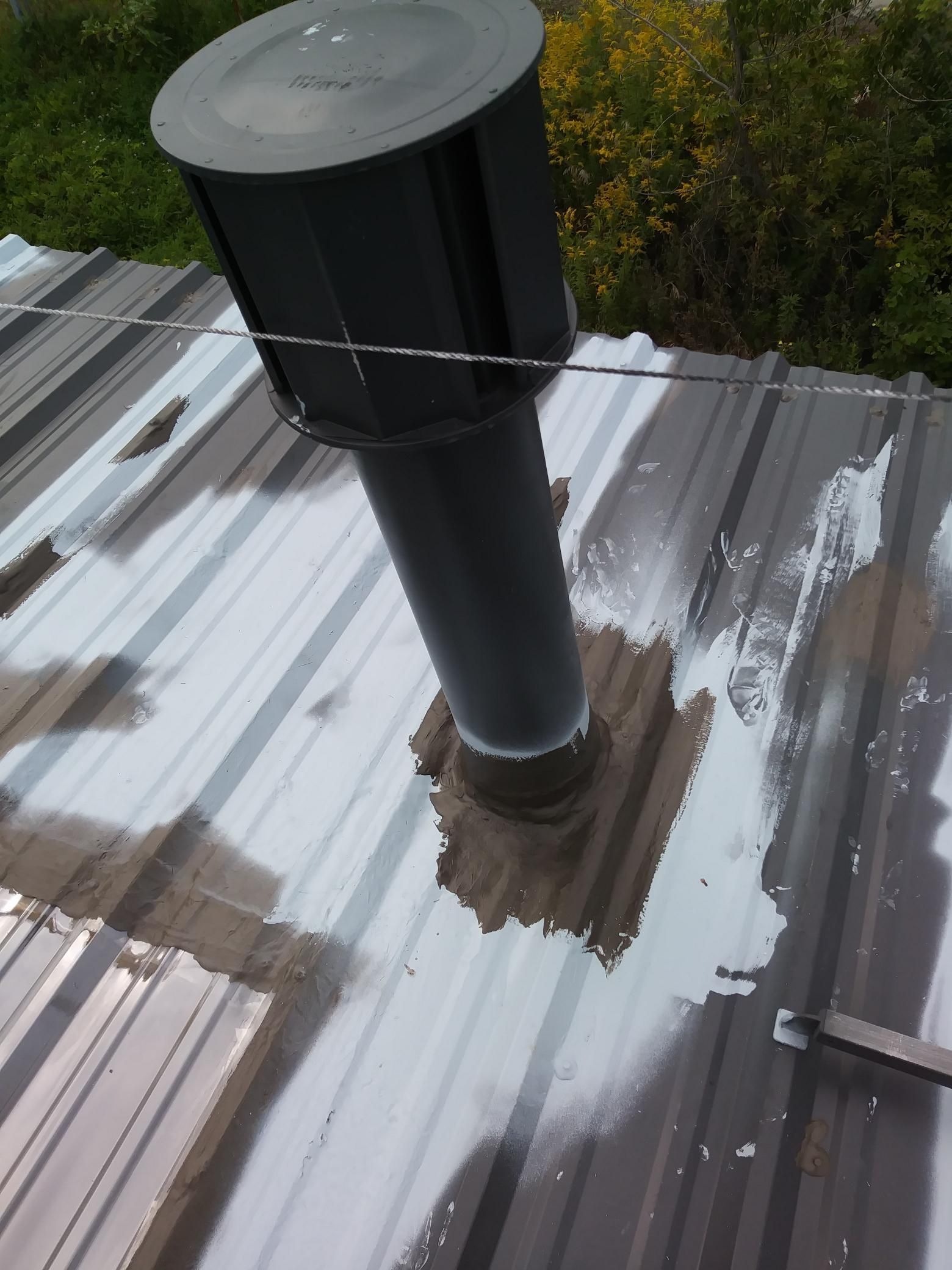 A metal roof with a chimney on top of it