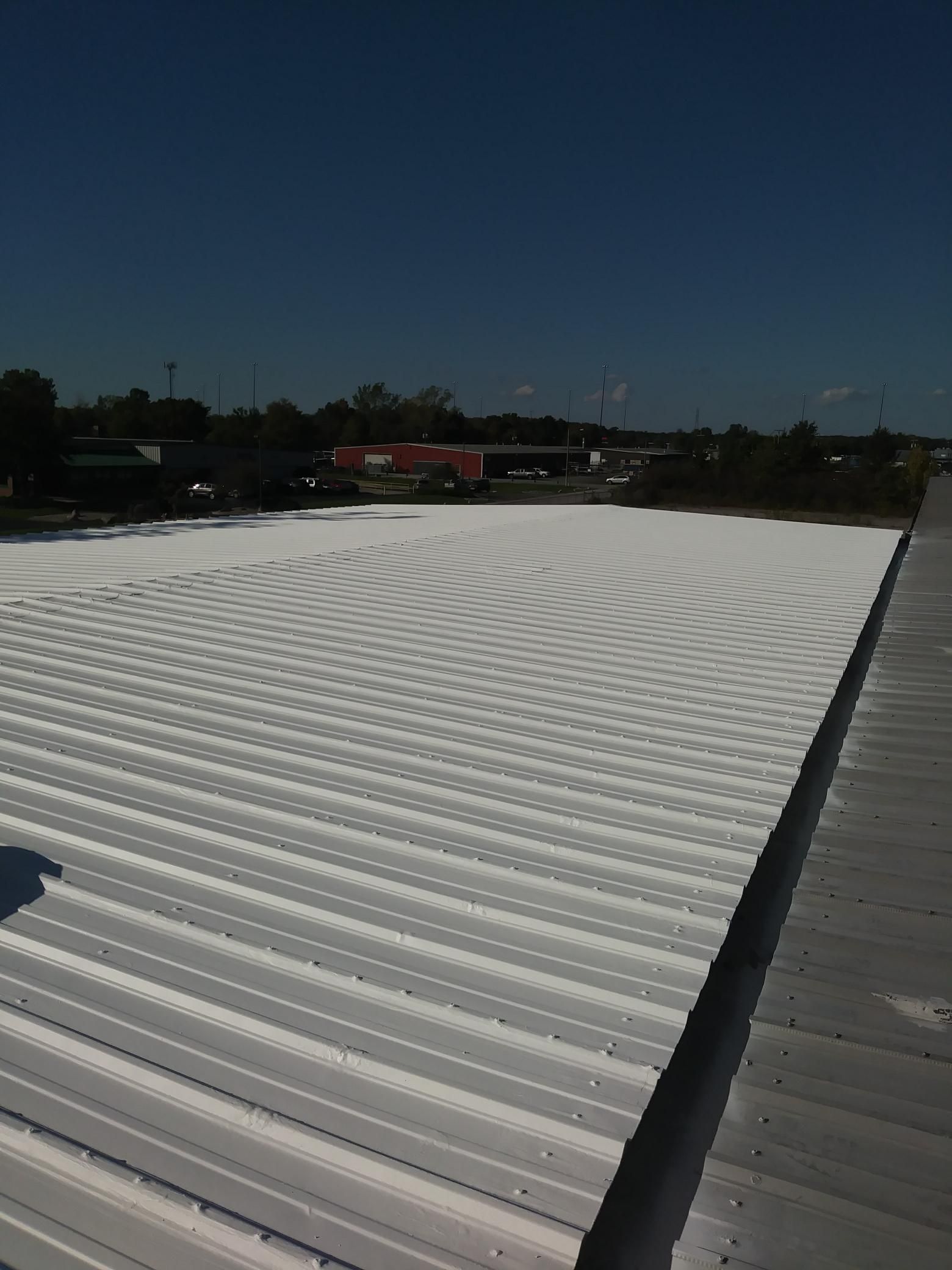 A large white roof with a blue sky in the background
