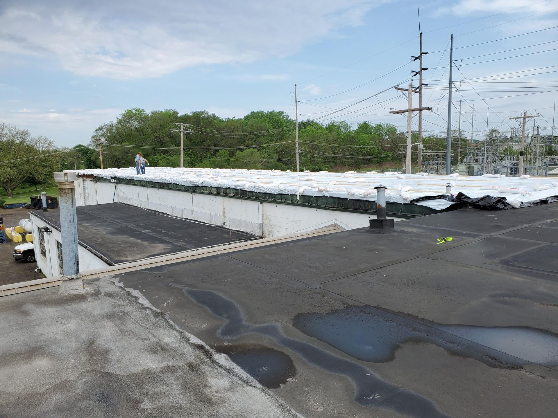 A man is working on the roof of a building.