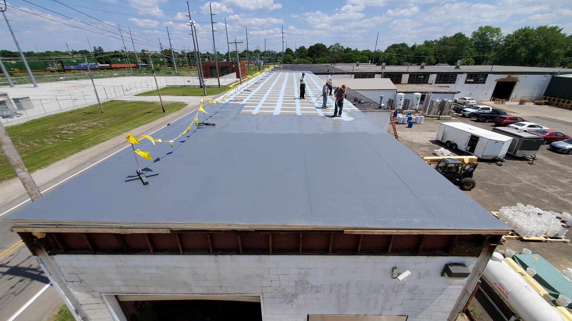 A group of people are working on the roof of a building.