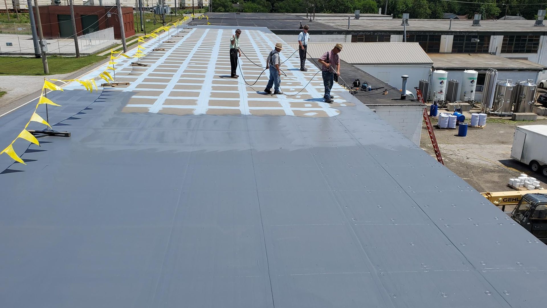 A group of people are standing on top of a roof.
