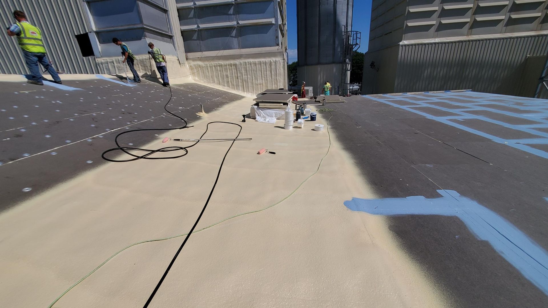 A group of people are working on a roof of a building.