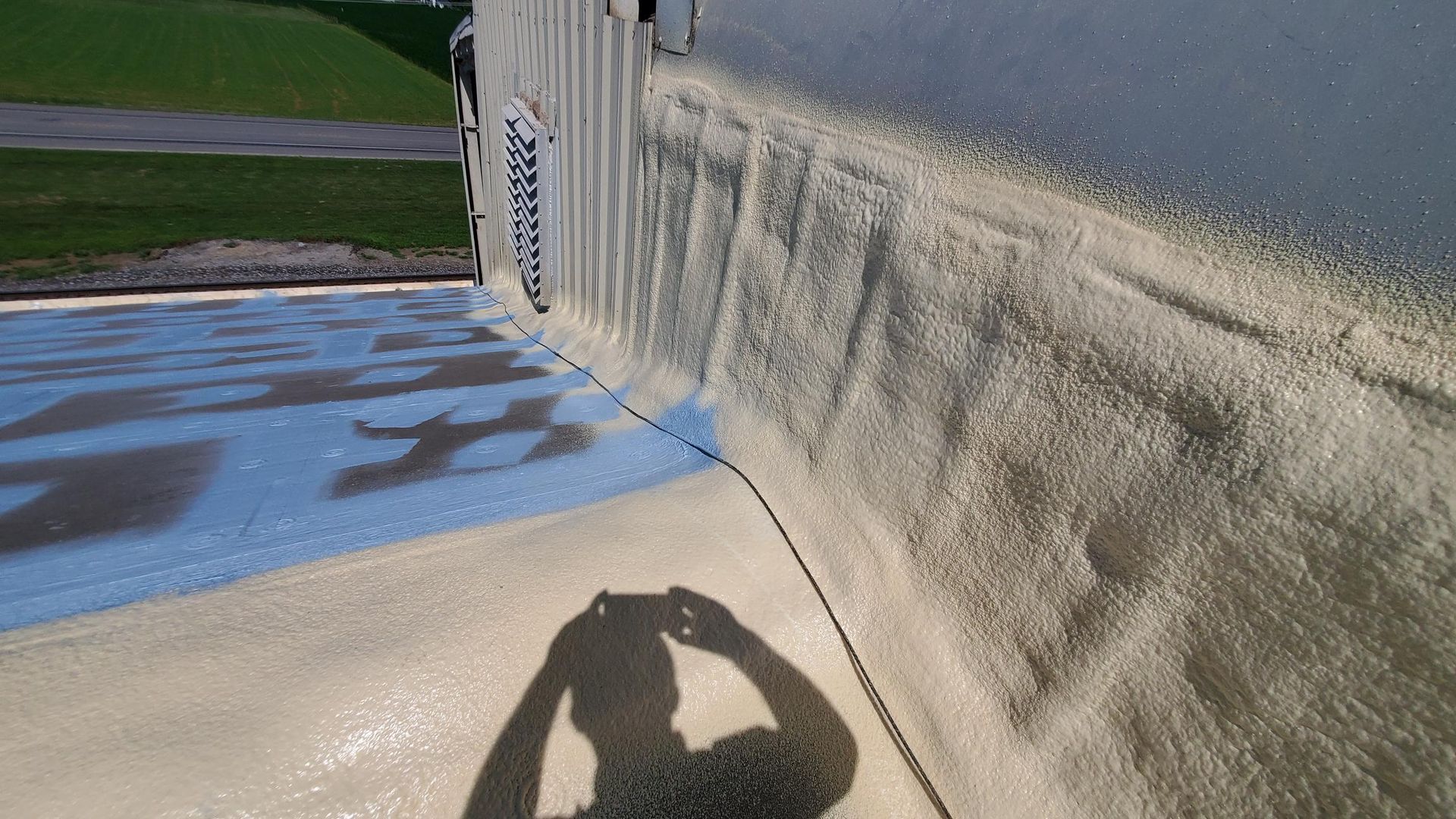 A person taking a picture of their shadow on a wall