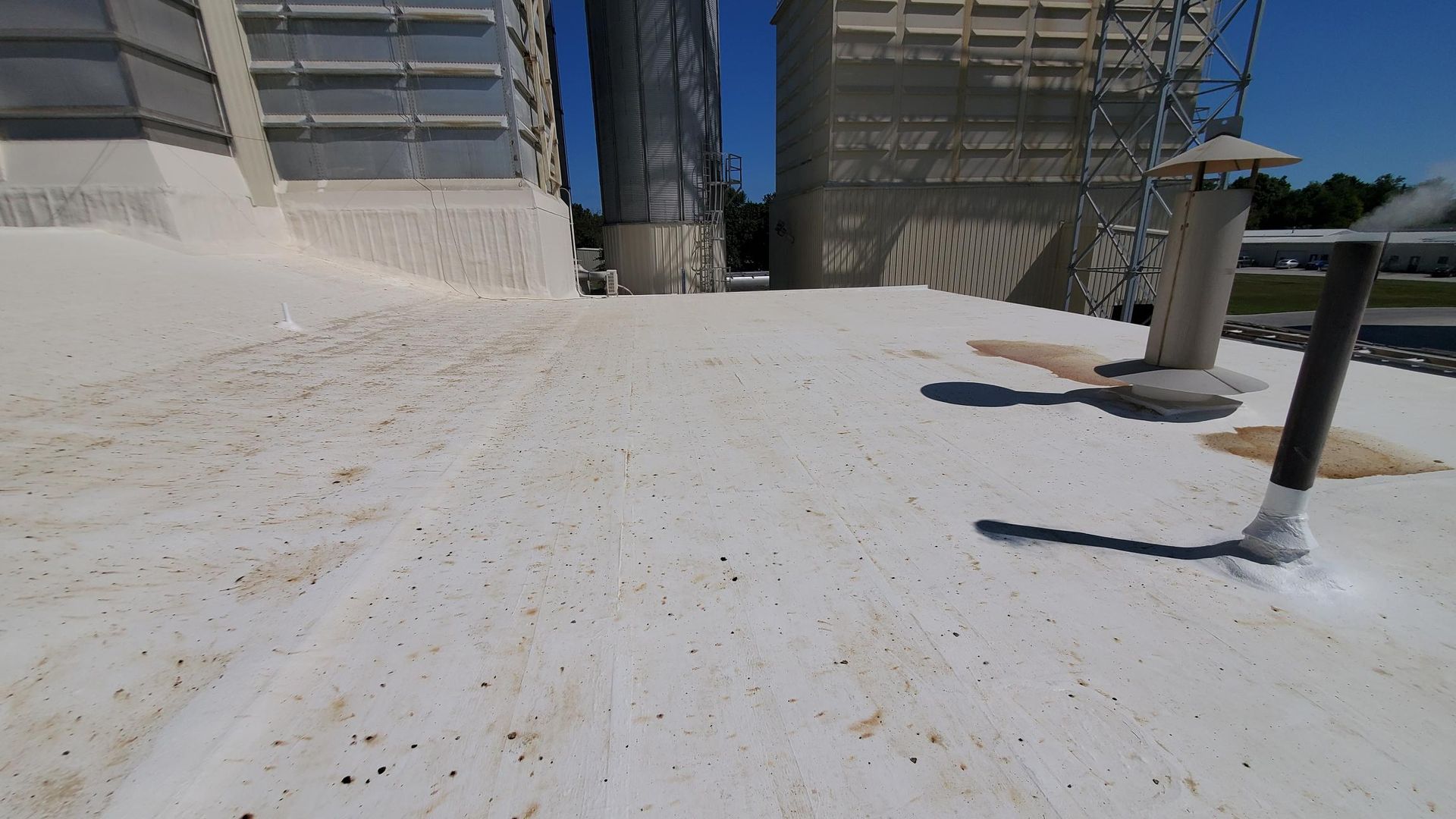 A white roof with a black pipe on it