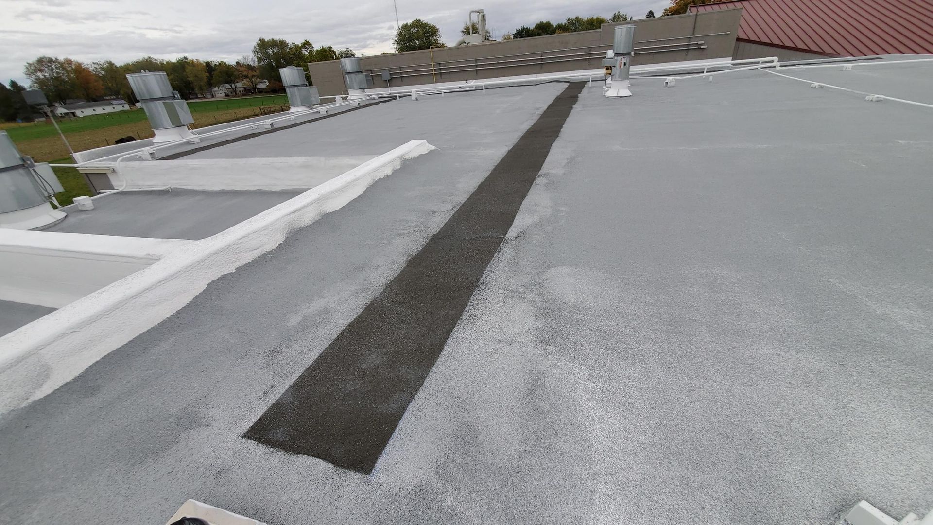 A close up of a roof with a black line on it.
