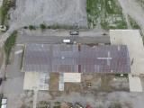 An aerial view of a church with a cross on the roof.
