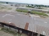 An aerial view of a warehouse with a metal roof.