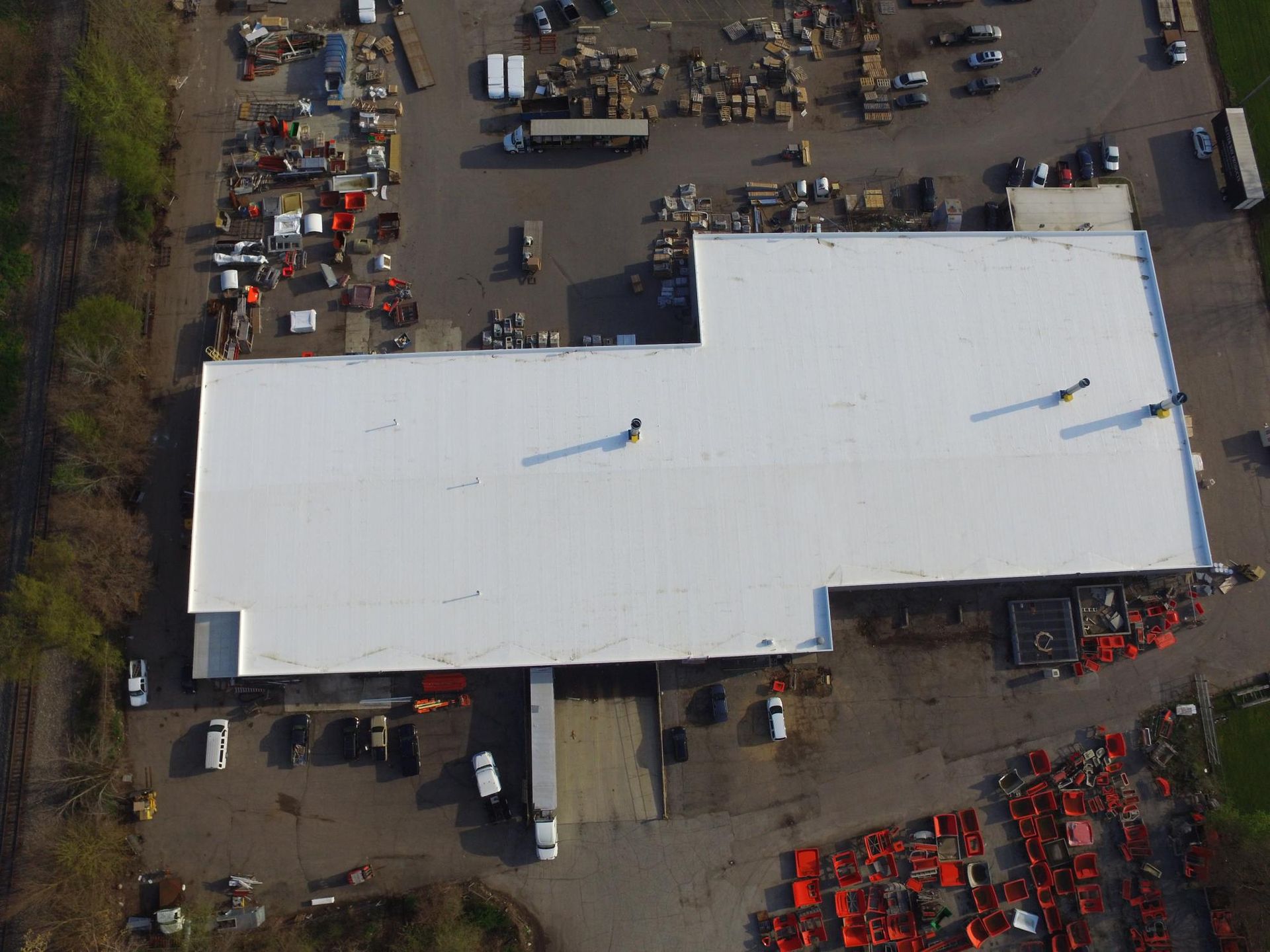 An aerial view of a large building with a white roof