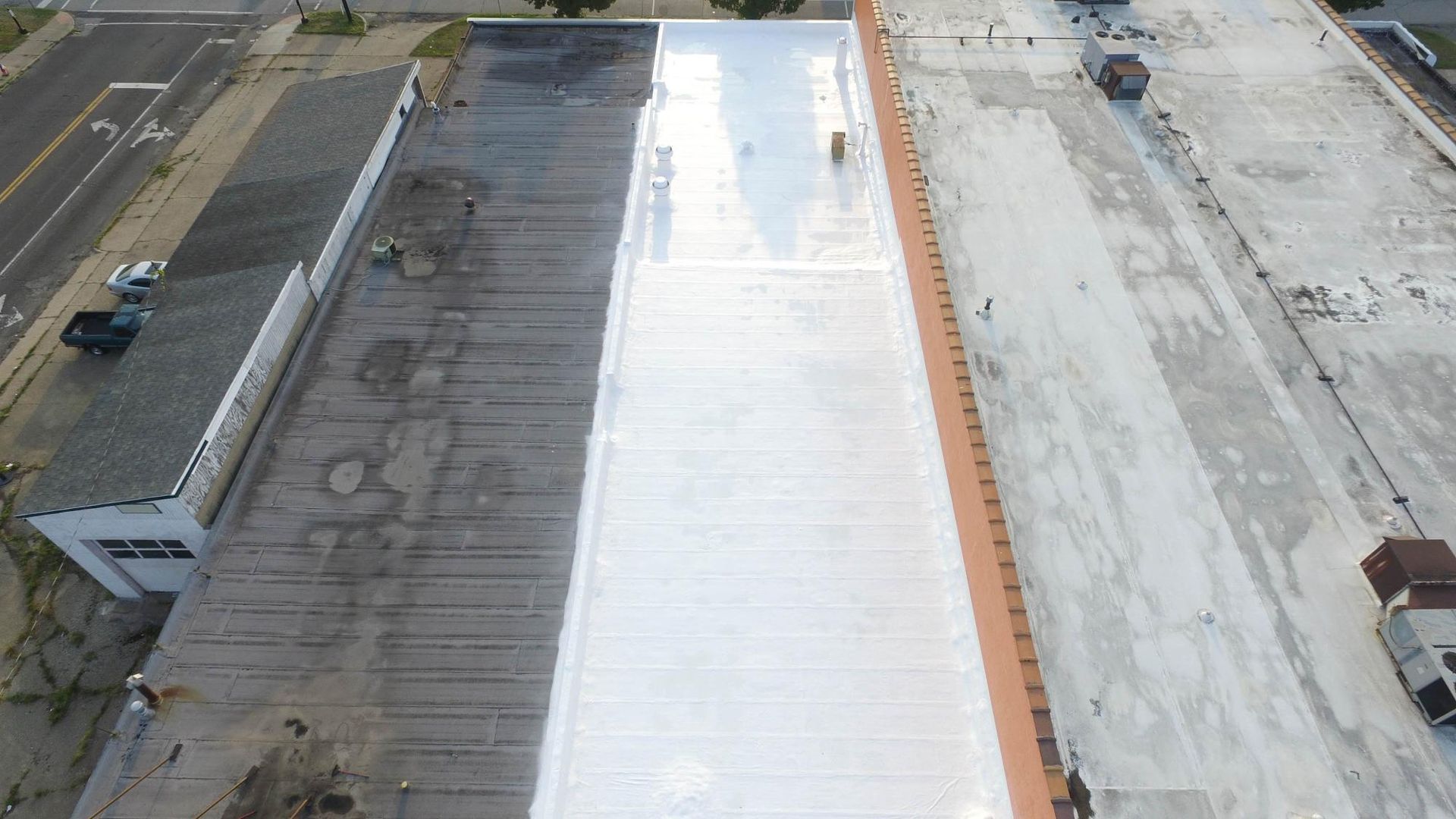 An aerial view of a building with a white roof.