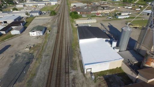 An aerial view of a building next to train tracks