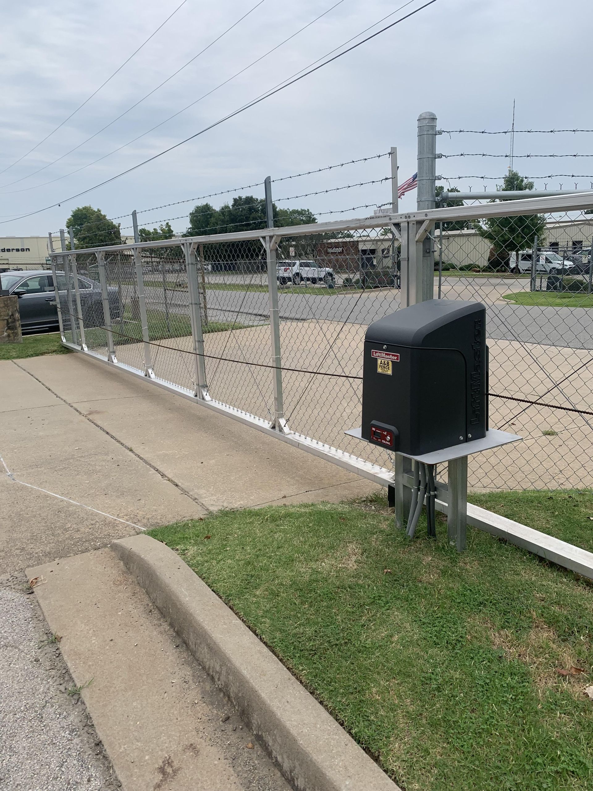A black box with a star on it is sitting next to a chain link fence.
