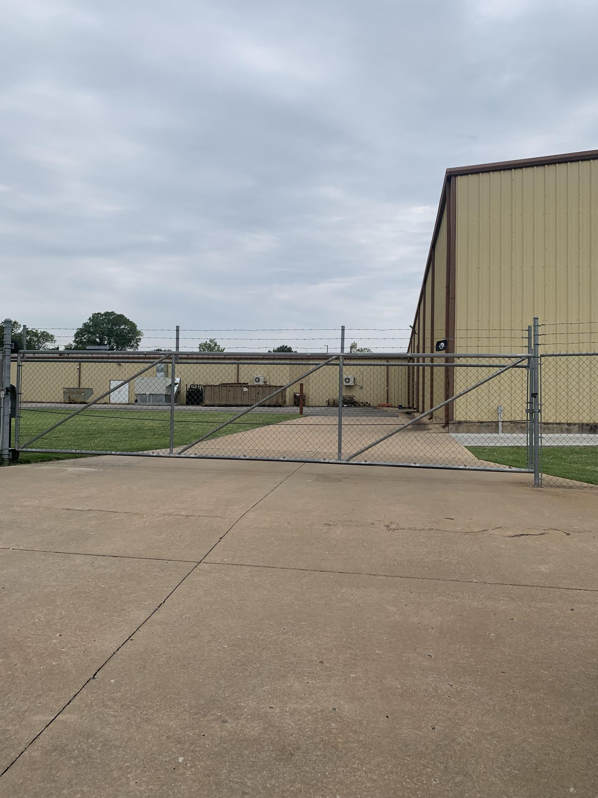 A large building with a chain link fence around it