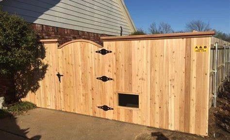 A wooden fence with a window in the middle of it.