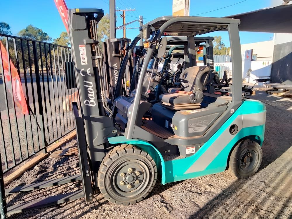 A Forklift Is Parked In Front Of A Fence — AHT Towing in Ciccone, NT