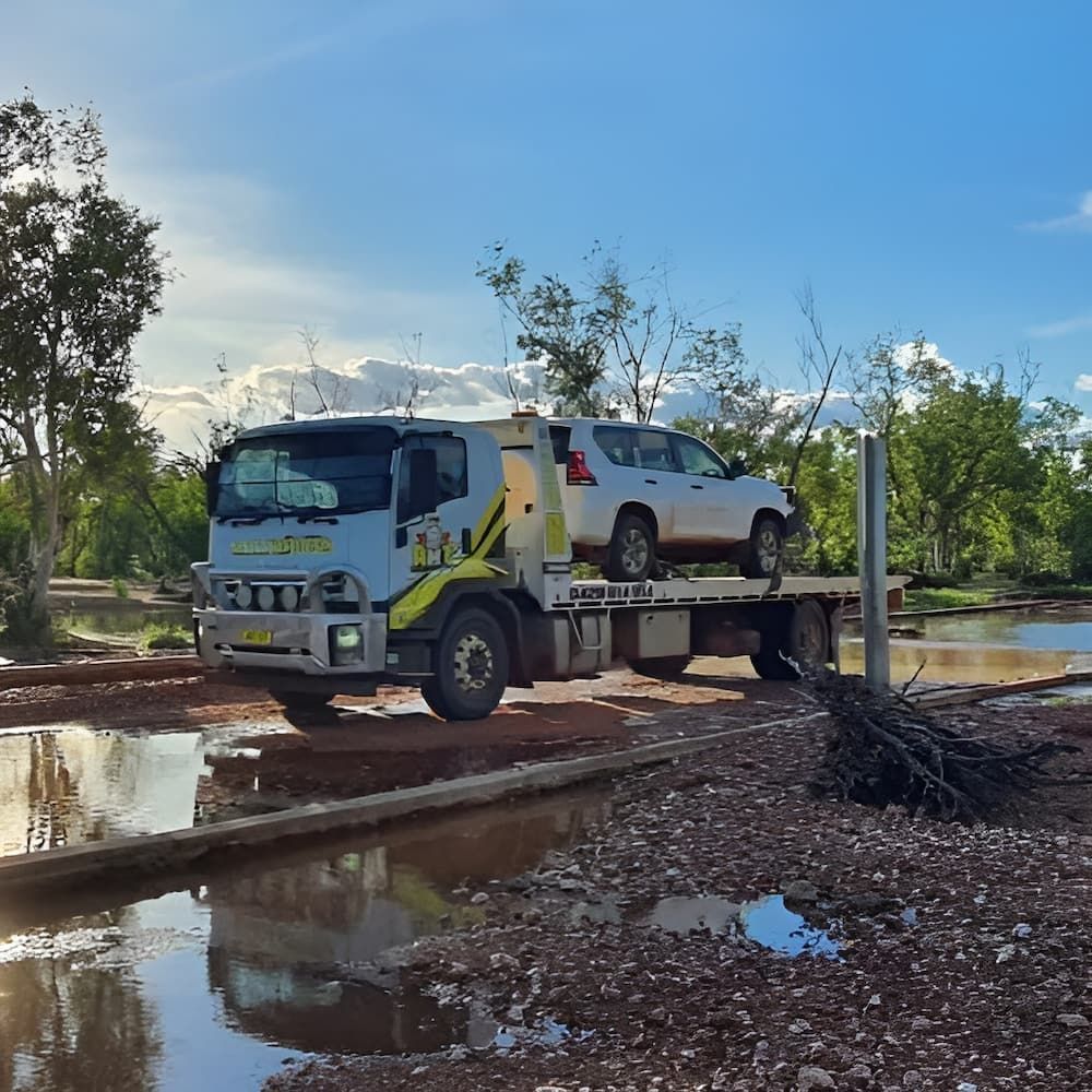 A Tow Truck With A Car On Top Of It — AHT Towing in Ciccone, NT