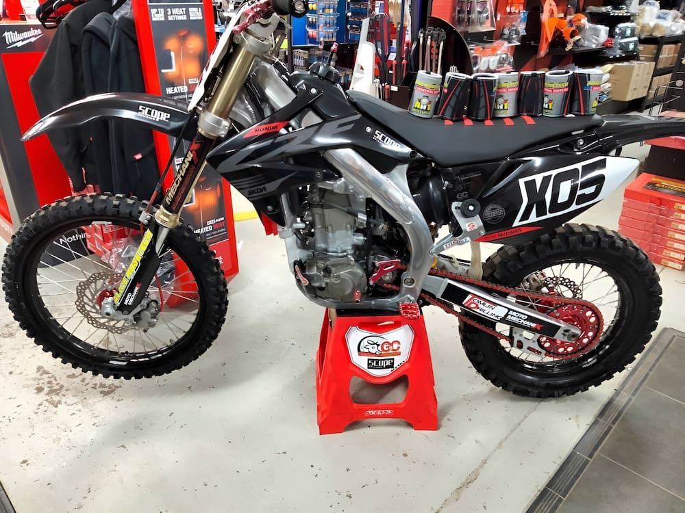 A Dirt Bike Is Sitting On A Red Stool In A Store — AHT Towing in Ciccone, NT