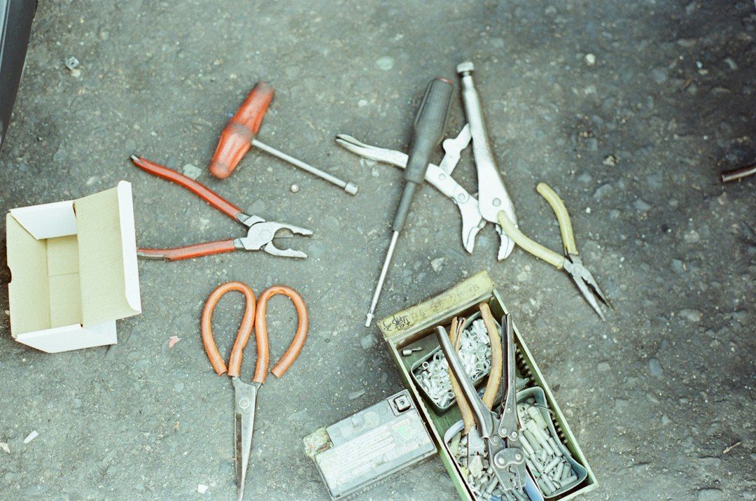 DIY drain cleaning tools laid out on a drop cloth