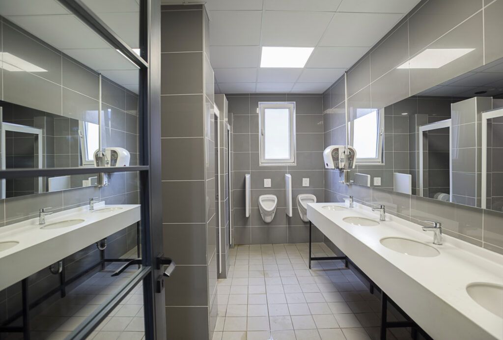 A public restroom with a lot of sinks and mirrors.