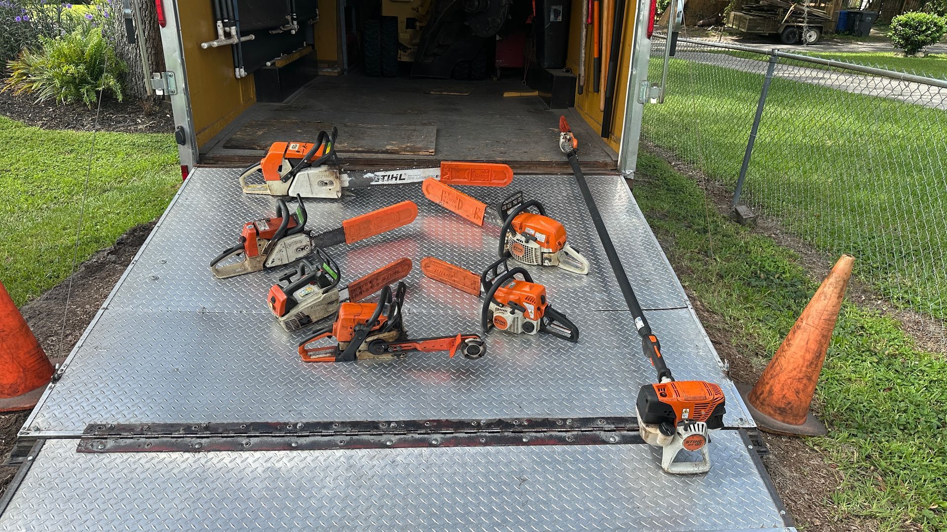 A bunch of chainsaws are sitting on top of a trailer.