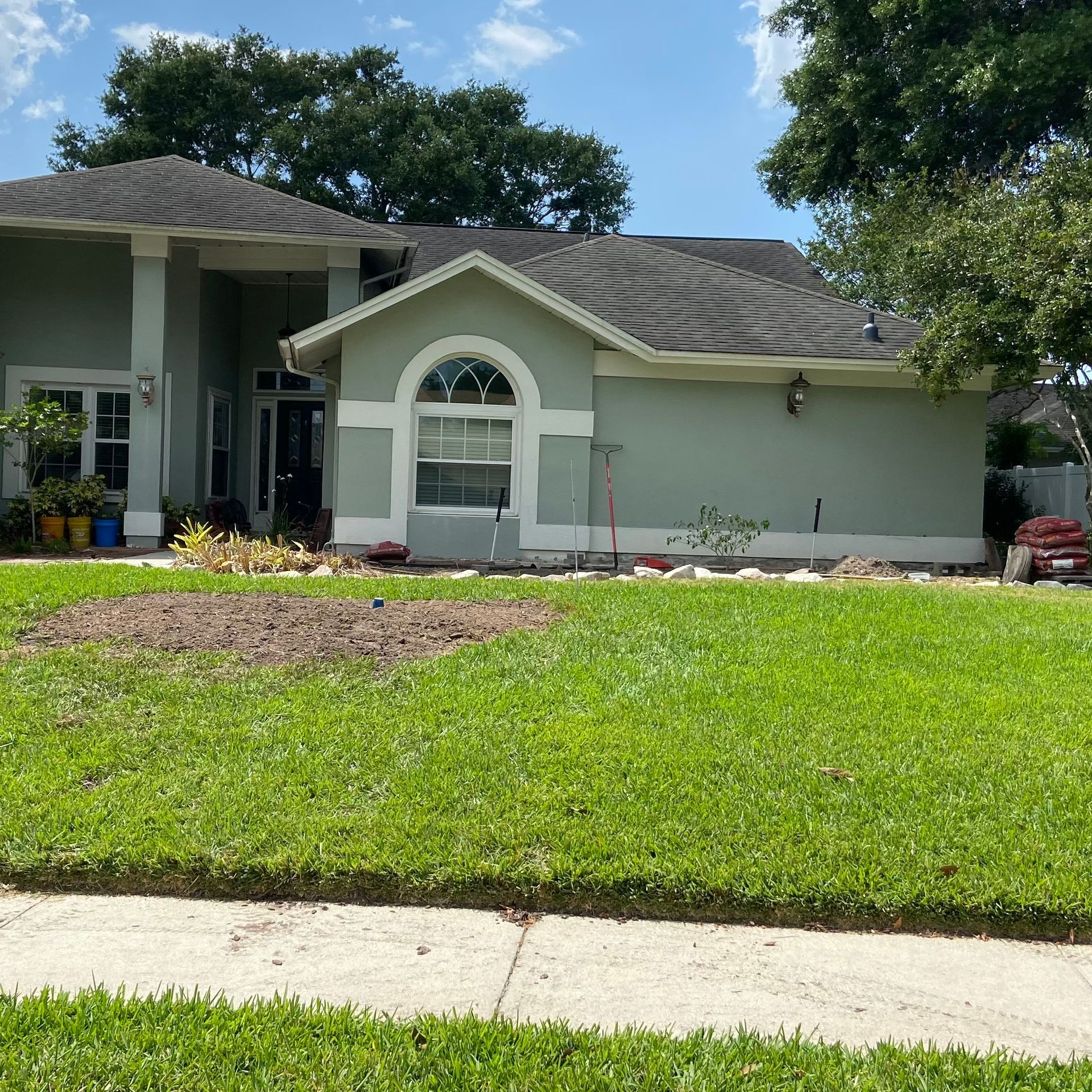 A house with a large lawn in front of it
