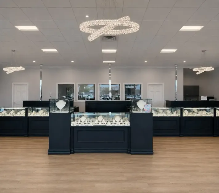 Bass' Fine Jewelry showroom with elegant glass display cases, modern lighting, and spacious interior.