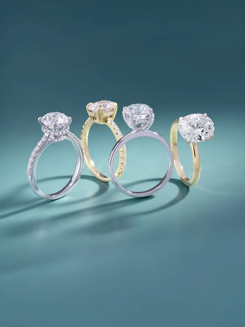 Custom diamond engagement rings in white and yellow gold settings.