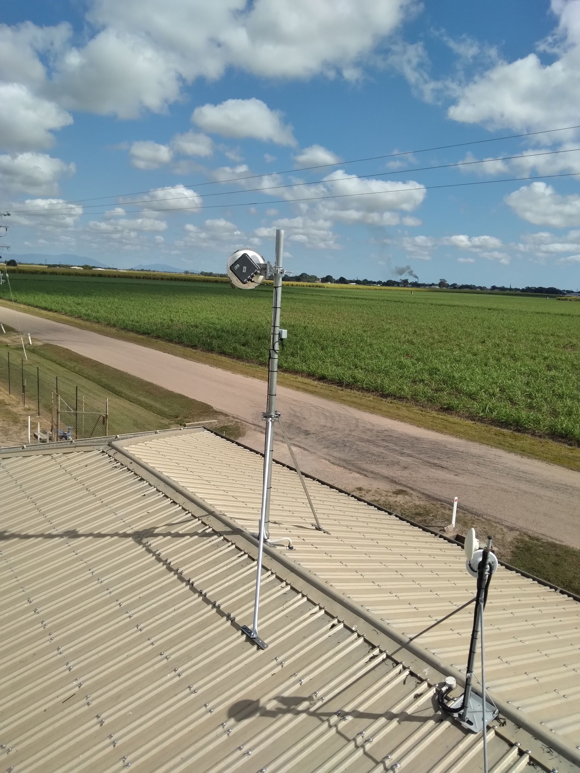 Person is Standing Next to a White Pole With a Black Box on It — Sape Industries in Charters Towers, QLD