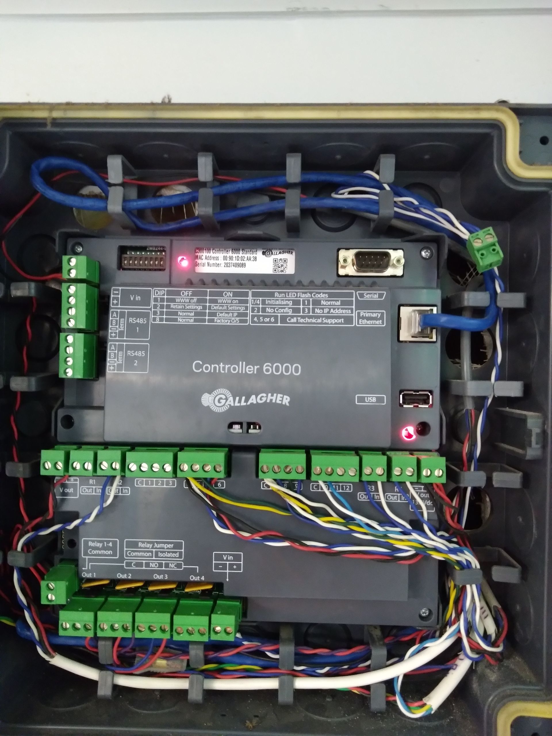 The inside of a control box with a lot of wires coming out of it