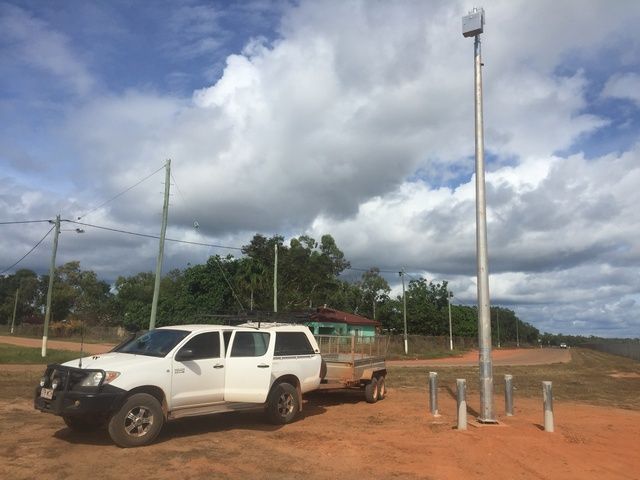 White Truck With a Trailer is Parked in a Dirt Field — Sape Industries in Garbutt, QLD