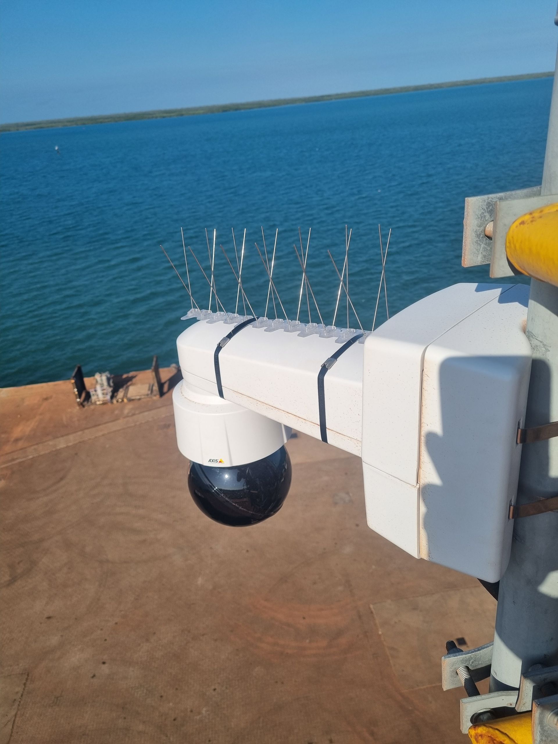 A camera mounted on a pole overlooking a body of water