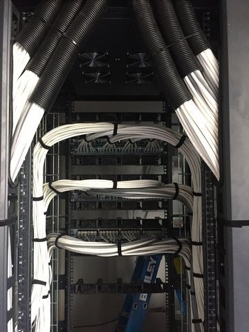 Bunch of Wires Are Hanging From the Ceiling of a Server Rack — Sape Industries in Garbutt, QLD