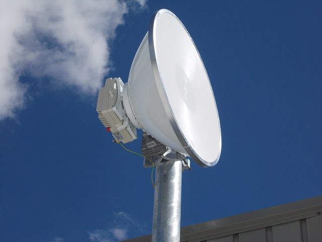 Satellite Dish on a Metal Pole With a Blue Sky in the Background — Sape Industries in Garbutt, QLD