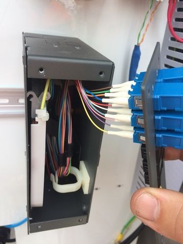 Person is Holding a Blue Optical Fiber Connector in Their Hand — Sape Industries in Garbutt, QLD