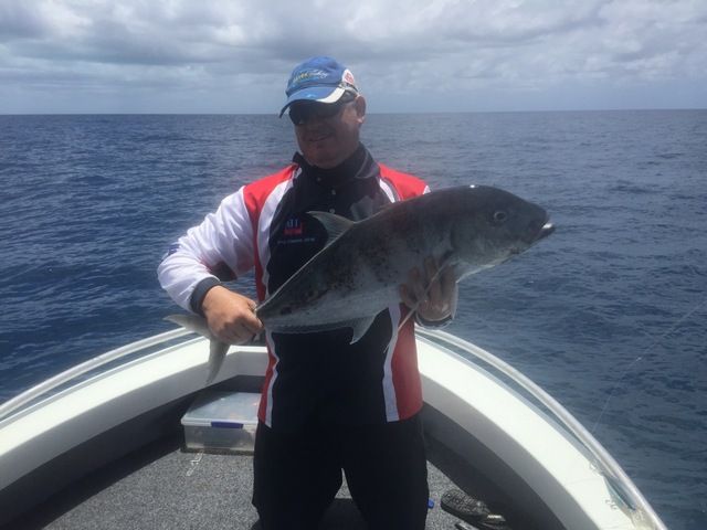 Man on a Boat Holding a Large Fish — Sape Industries in Garbutt, QLD