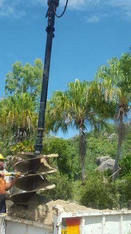 Man is Using a Crane to Dig a Hole in the Ground — Sape Industries in Garbutt, QLD