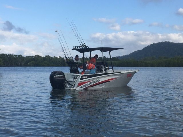 Boat is Floating on a Lake With Mountains in the Background — Sape Industries in Garbutt, QLD