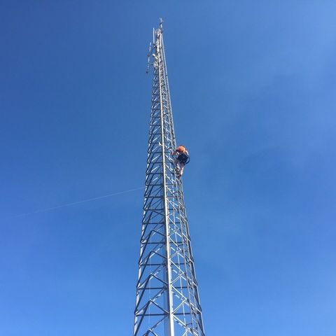 Man is Climbing Up a Very Tall Metal Tower — Sape Industries in Garbutt, QLD