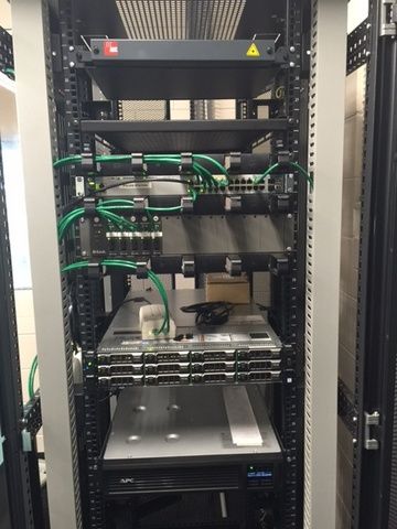 Server Rack With a Lot of Wires Coming Out of It — Sape Industries in Garbutt, QLD